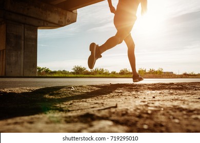 Low Angle Shot Of A Man Running Outdoors.