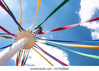 A low angle shot of a Maypole with colorful strings at Countryfile Live, Oxfordshire