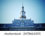 A low angle shot of old Quebec Seminary tower of in Montreal, Quebec, Canada under blue sky