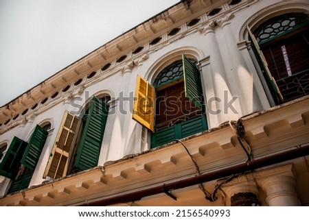 A low angle shot of the open windows of the Jorasako Thakurbari ancestral home in Kolkata, India