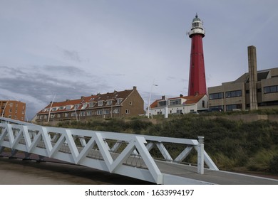 A low angle shot of a red lighthouse at  Scheveningen Beach in  Scheveningen Netherlands