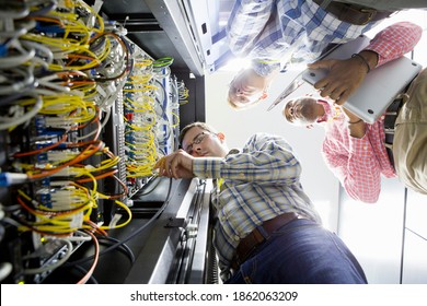 Low angle shot of technicians checking the server in the data center