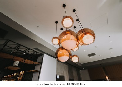 A Low Angle Shot Of Unique And Modern Chandelier In A Minimalistic Bedroom