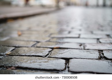 Low Angle Shot Of Wet Old Pavement In Tallinn With Shallow Focus