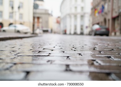 Low Angle Shot Of Wet Old Pavement In Tallinn With Shallow Focus