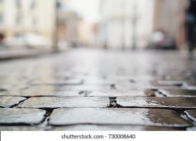 Low Angle Shot Of Wet Old Pavement In Tallinn With Shallow Focus