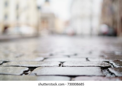 Low Angle Shot Of Wet Old Pavement In Tallinn With Shallow Focus