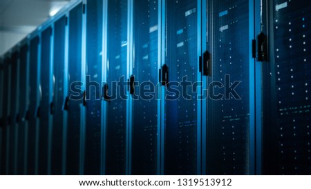 Low Angle Shot of a Working Data Center With Rows of Rack Servers. Led Lights Blinking and Computers are Working.