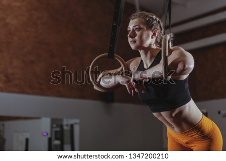 Similar – young adult trained woman concentrate at her excercise in gym