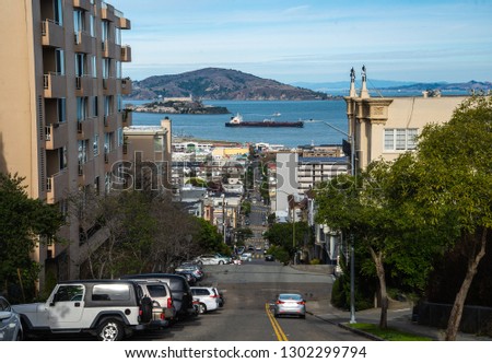 Low angle twilight view of an empty road with cable car tracks leading up a steep hill at famous California Street at dawn, San Francisco, California, USA