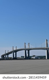 Low angle vertical view of a modern concrete cable stayed bridge with ample copy space under a clear blue sky, Fukushima Japan.
