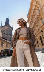 Low Angle View Of African American Woman Posing Near Old Town Hall Tower In Prague