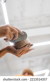 Low Angle View Of African American Woman Sculptor Making Clay Product In Workshop