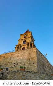 Low angle view of a ancient clock tower of Mosque of Suleyman in Rhodes Old Town, Rhodes island, Greece.
