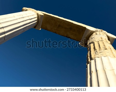 Low angle view of ancient marble columns and architrave against deep blue sky at Knidos Ancient City, Datca, Turkey