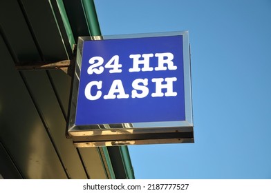 Low angle view of ATM - 24 HR CASH sign attached to building against a clear blue sky. - Shutterstock ID 2187777527