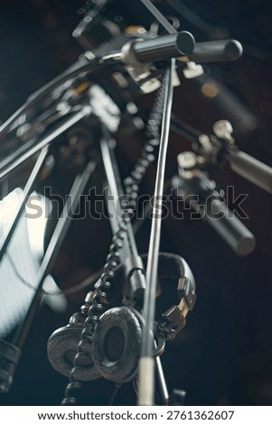  Low angle view of audio production headphones and microphones in a recording studio. Dark blue cinematic atmosphere, blurred background with cables