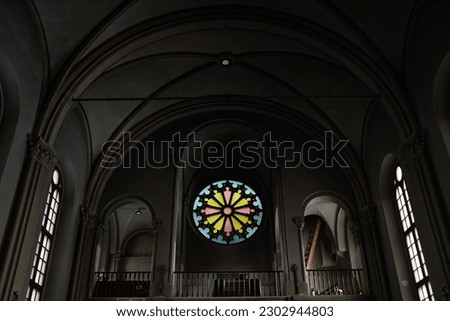 Low angle view of baptist church with dark walls and stained glass inside