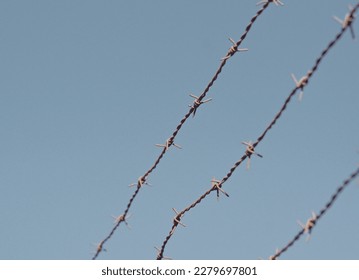 Low angle view of barbed wire against clear sky - Shutterstock ID 2279697801