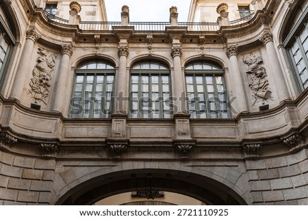 Low angle view of the Baroque architectural details and stone arches of the Virreina Palace in Barcelona.