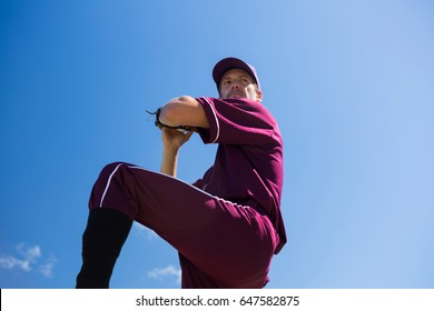 Low angle view of baseball pitcher throwing ball against blue sky on sunny day - Powered by Shutterstock