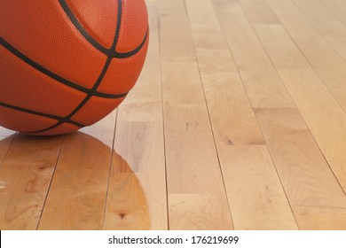 Low Angle View Of A Basketball On A Wooden Gymnasium Floor