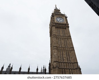 Low angle view of Big Ben and ornate Elizabeth Tower rising above the Houses of Parliament in London, UK.