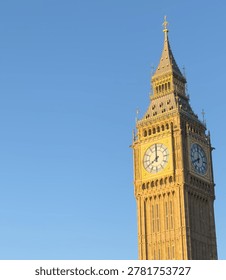 Low angle view of the Big Ben Elizabeth Tower clock face against a clear blue sky in London