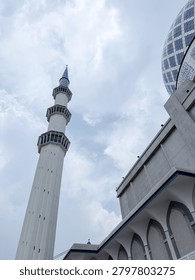 Low angle view of the Blue Mosque featuring its iconic dome and minaret, representing Islamic architecture, religion, culture, worship, and spiritual heritage concepts.