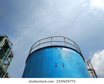 low angle view of blue storage tank with copy space