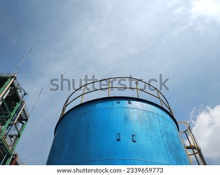 low angle view of blue storage tank with copy space