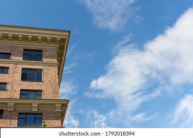 Low angle view of brick building. Blue sky with some clouds. Copy space for your text. Architecture theme.
