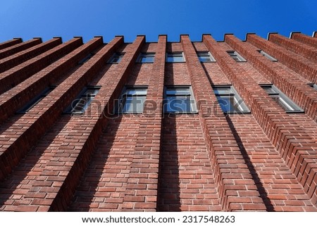 Low angle view of brick building against clear blue sky