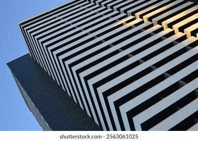 Low angle view of building corner against clear blue sky