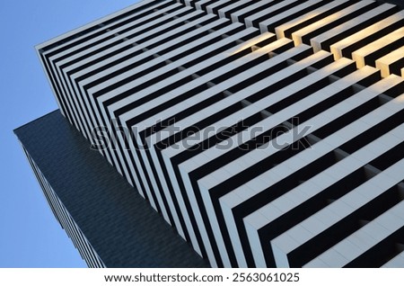 Low angle view of building corner against clear blue sky
