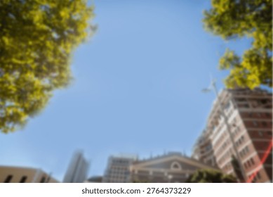 Low angle view of buildings and trees against sky in city