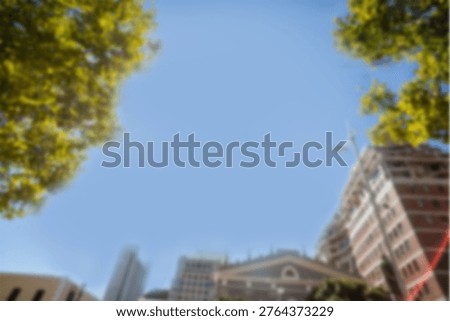 Low angle view of buildings and trees against sky in city