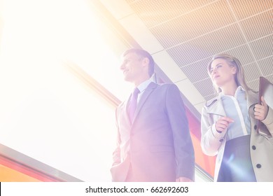 Low Angle View Of Business People Walking In Railroad Station