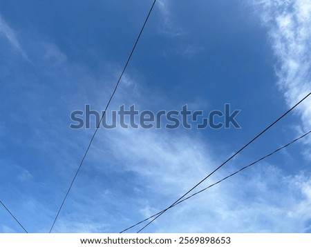 Low Angle View Of Cables Against Blue Sky