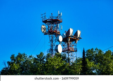 A Low Angle View Of A Cell Site Tower Housed On A Cable Stayed Steel Lattice Pylon, Microwave Antenna For 3G, 4G, 5G Data Transfer And Signal Boost