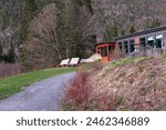 Low angle view of chairs in front of small cabin in the Jacques-Cartier National Park in spring, Stoneham-et-Tewsksbury, Quebec, Canada