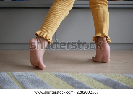 low angle view of A child walking on tiptoes