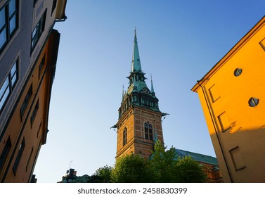 Low angle view of a church tower against the sky  - Powered by Shutterstock