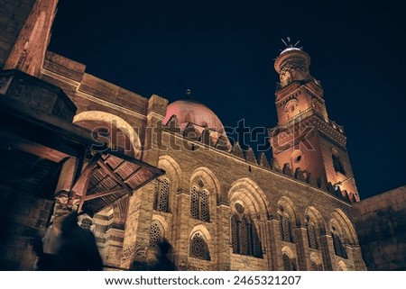 Low angle view of Complex of Sultan al-Mansur Qalawun. Streets of Khan El Khalili bazaar in Cairo, Egypt. Night Cairo street