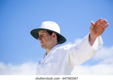 Low angle view of cricket umpire signalling a boundary at match - Powered by Shutterstock