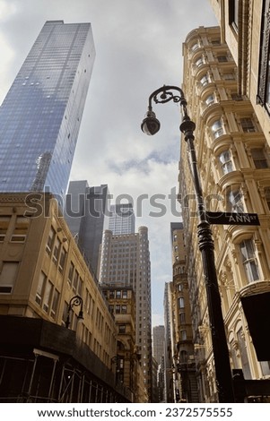 low angle view of decorated lantern near vintage buildings and modern skyscrapers in new york city