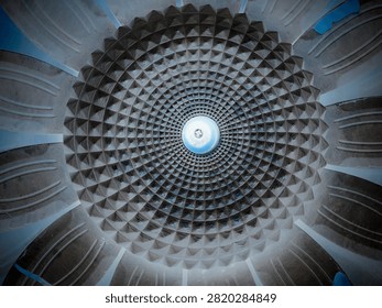 Low angle view of a dome ceiling with intricate geometric radial pattern and central skylight. Taken In Malang, East Java, Indonesia On July 30 2026