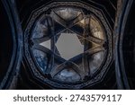 Low angle view of dome of temple or synagogue with hexagram in center. Star of David or Seal of King Solomon in ancient temple Symbol of Israel in stone structure Armenian temple with six pointed star