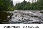 A low angle view down the rushing river in spring