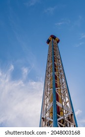 Low Angle View Of Drop Tower Ride And Rural Amusement Park.